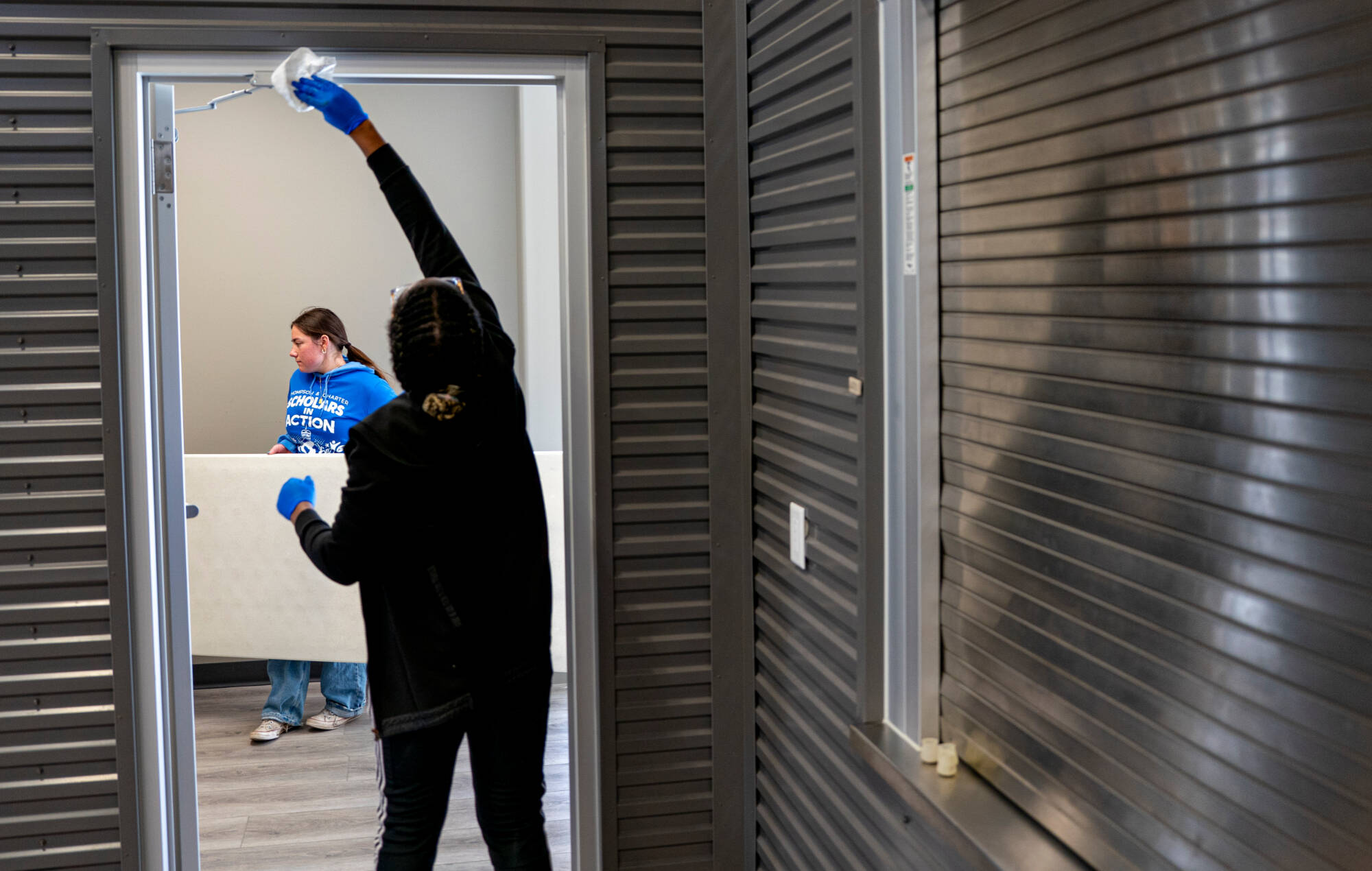 student cleaning doorway